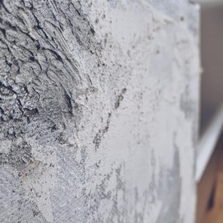 Raue Oberfläche mit grauer Struktur, Detailaufnahme der abstrakten Kunst.